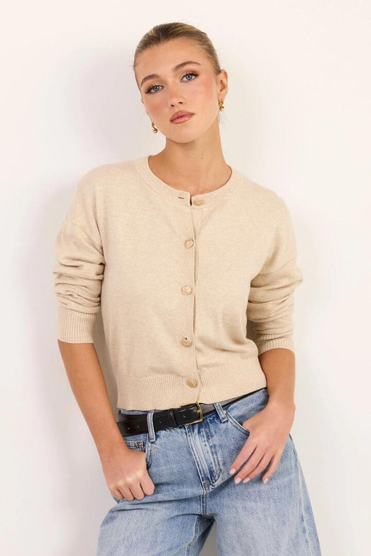 Image of a model wearing Outerwear. Product name - Delight Champagne Cotton Cashmere Fine Knit Crew Cardigan in Champagne colour by brand - Ivy + Jack