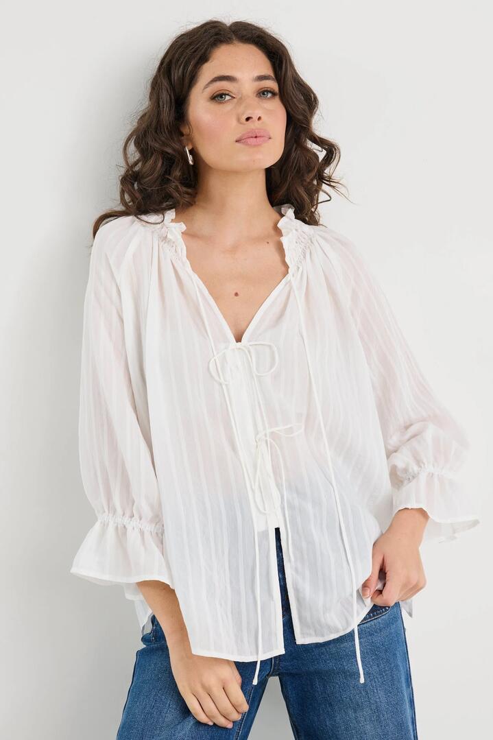Image of a model wearing Tops. Product name - Prospect Ivory Stripe Tie Front Mid Sleeve Top in Ivory Stripe colour by brand - Among the Brave