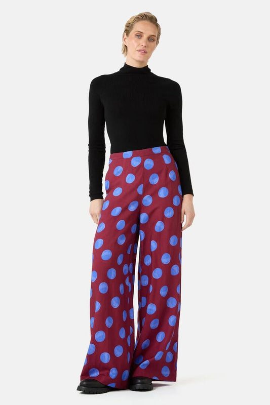 Image of a model wearing Pants. Product name - On The Dot Wide Pants in Wine colour by brand - Gorman
