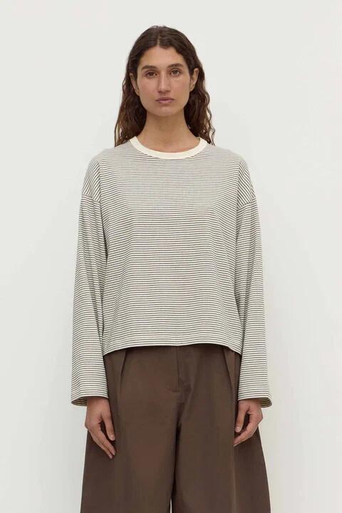 Image of a model wearing Tops. Product name - Malone Cream Black Stripe Cropped Long Sleeve Tee in Cream colour by brand - Assembly Label