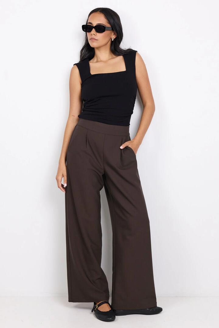 Image of a model wearing Pants. Product name - Instinctive Dark Chocolate Petite Wide Leg Elastic Back Pants in Dark Chocolate colour by brand - Among the Brave