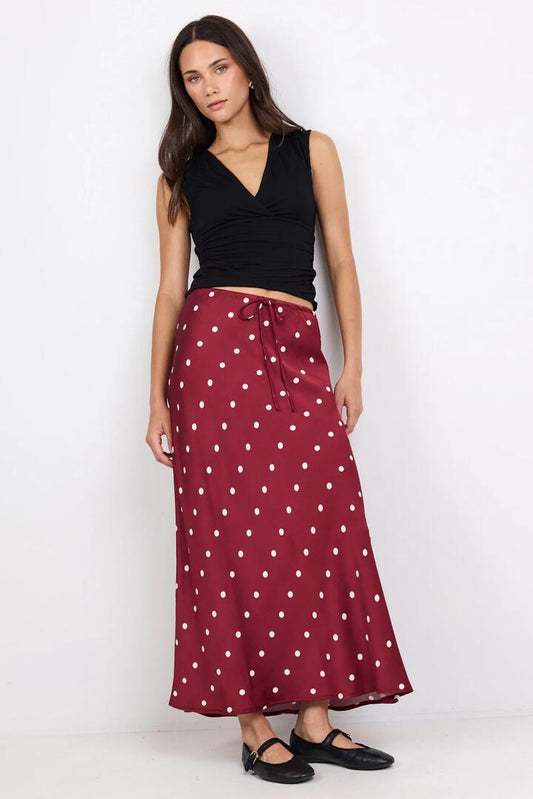 Image of a model wearing Skirts. Product name - Rarity Wine Cream Polka Dot Satin Tie Waist Bias Maxi Skirt in Wine Cream Polka Dot colour by brand - Stories be Told