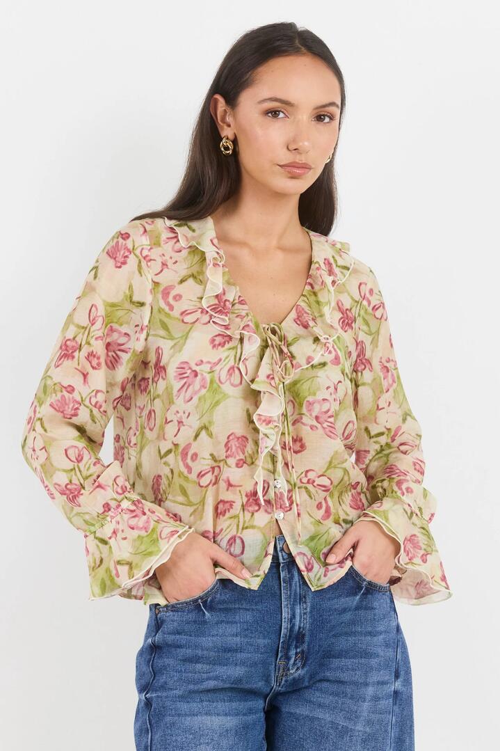 Image of a model wearing Tops. Product name - Bohemian Cream Blush Floral Sheer Frill Front Blouse in Cream Blush Floral colour by brand - Among the Brave