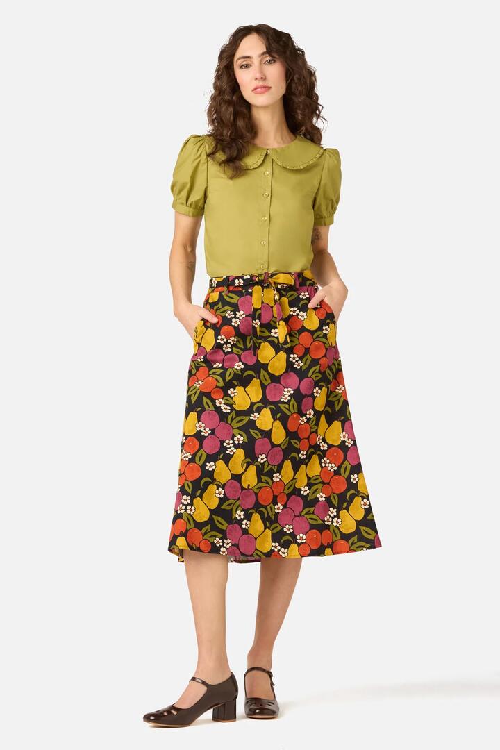 Image of a model wearing Skirts. Product name - Fancy Fruit Midi Skirt in Navy colour by brand - Princess Highway