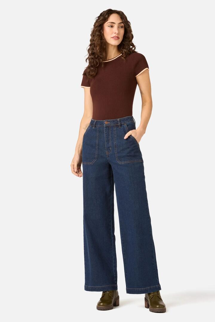 Image of a model wearing Pants. Product name - Whitney Wide Leg Jean in Mid Denim colour by brand - Princess Highway