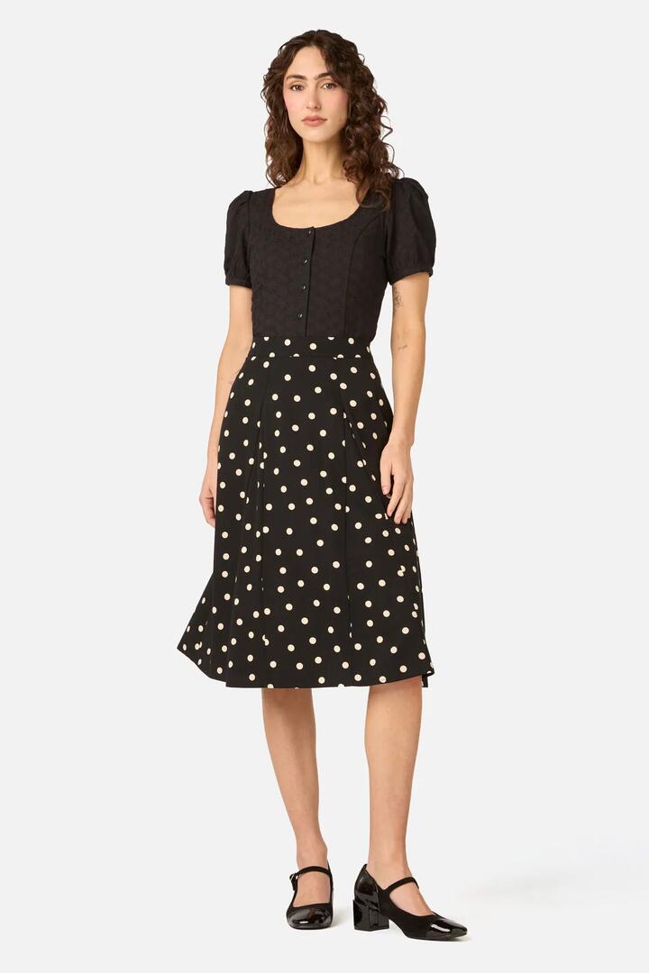 Image of a model wearing Skirts. Product name - Kelly Polka Dot Skirt in Black colour by brand - Princess Highway