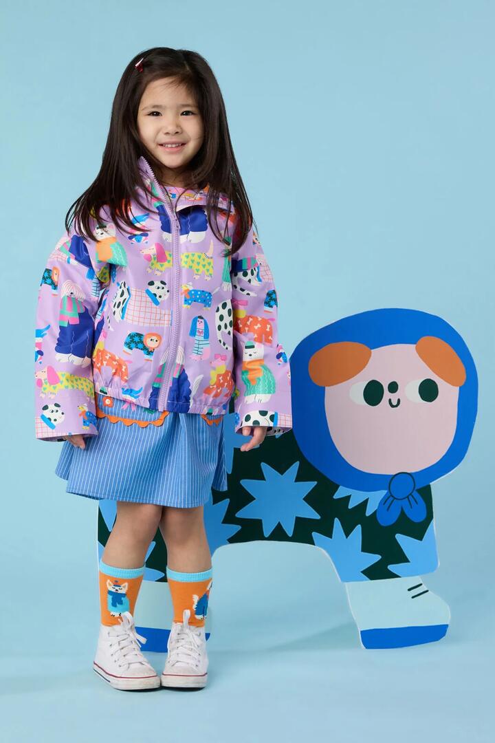 Image of a model wearing Rain Coats. Product name - Sweater Dogs Kids Raincoat in Lilac colour by brand - Gorman