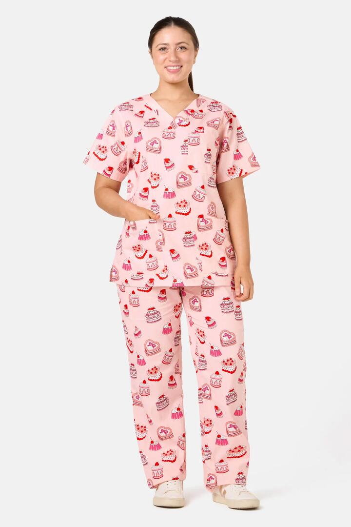Image of a model wearing Uniforms & Workwear. Product name - Cake Party Scrub Set in Pink colour by brand - Scrubs With Love