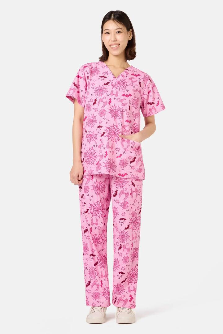 Image of a model wearing Uniforms & Workwear. Product name - Spooky Season Scrub Set in Pink colour by brand - Scrubs With Love