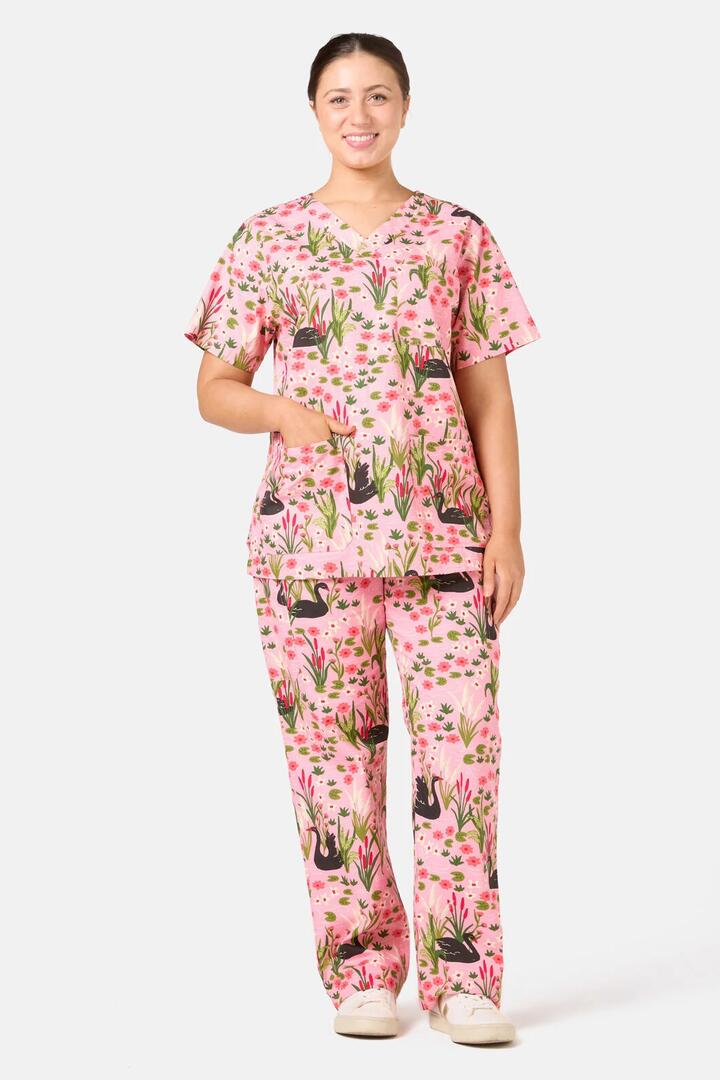 Image of a model wearing Uniforms & Workwear. Product name - Pretty Swans Scrub Set in Pink colour by brand - Scrubs With Love
