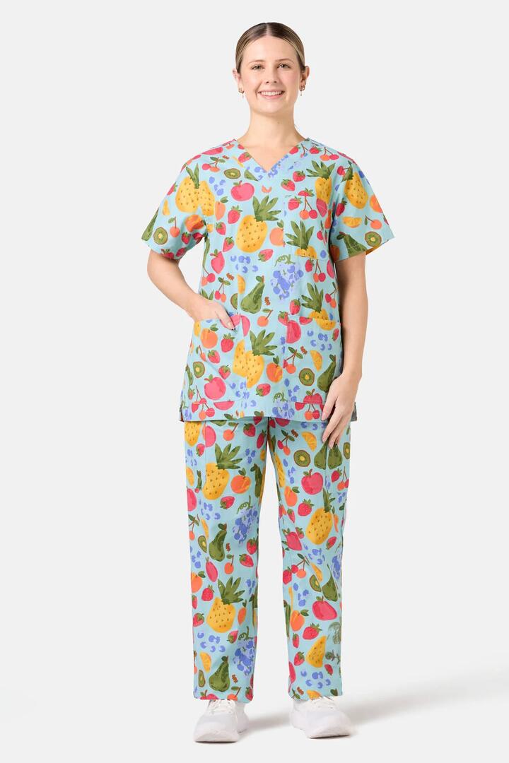 Image of a model wearing Uniforms & Workwear. Product name - Blue Fruitbowl Scrub Set in Blue colour by brand - Scrubs With Love