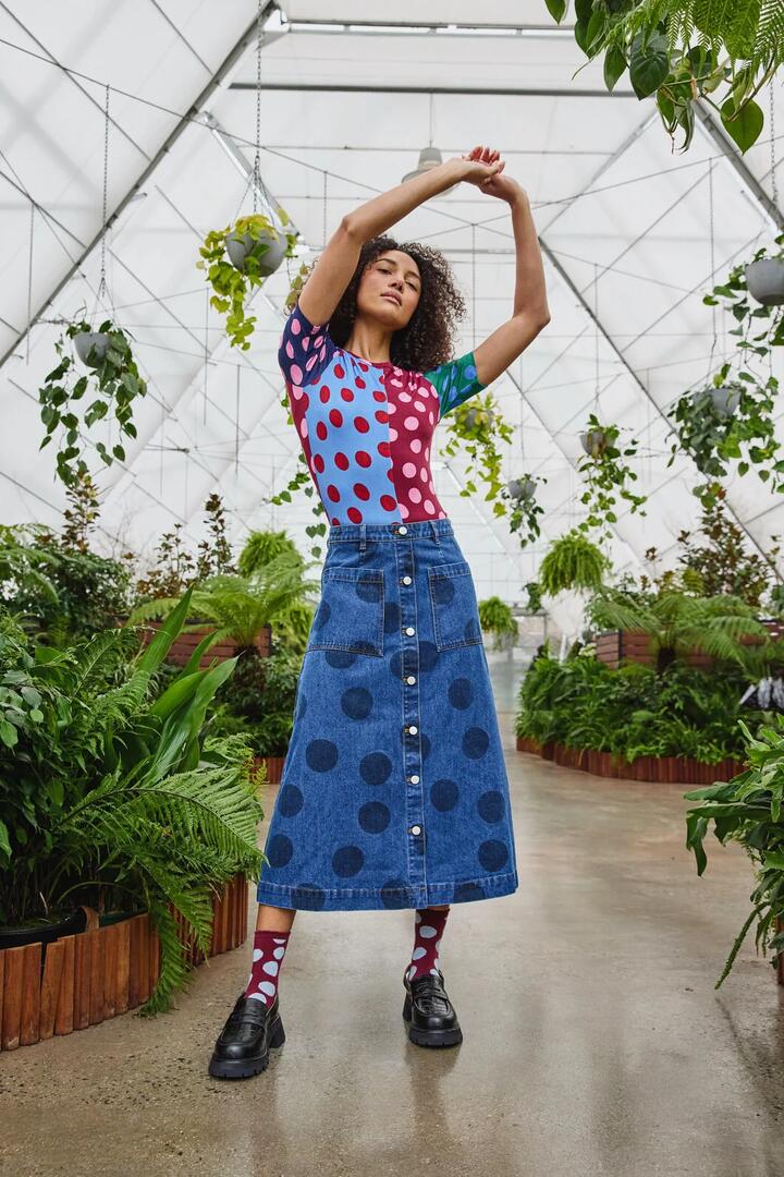Image of a model wearing Skirts. Product name - On The Dot Denim Skirt in Denim colour by brand - Gorman
