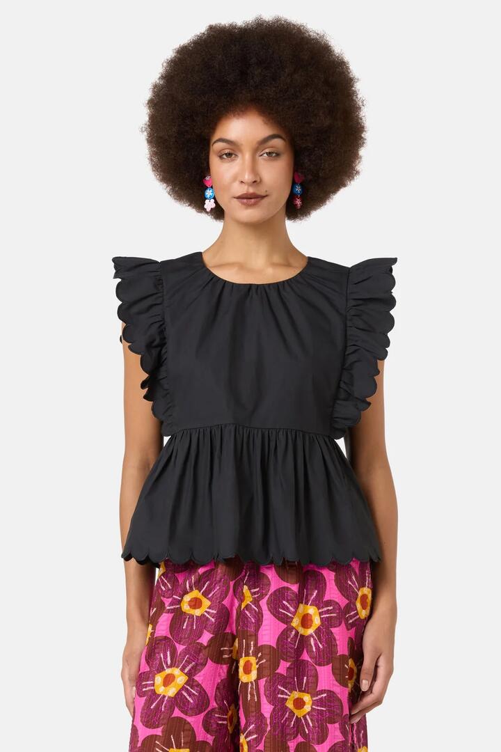 Image of a model wearing Tops. Product name - Lily Ruffle Top in Black colour by brand - Gorman
