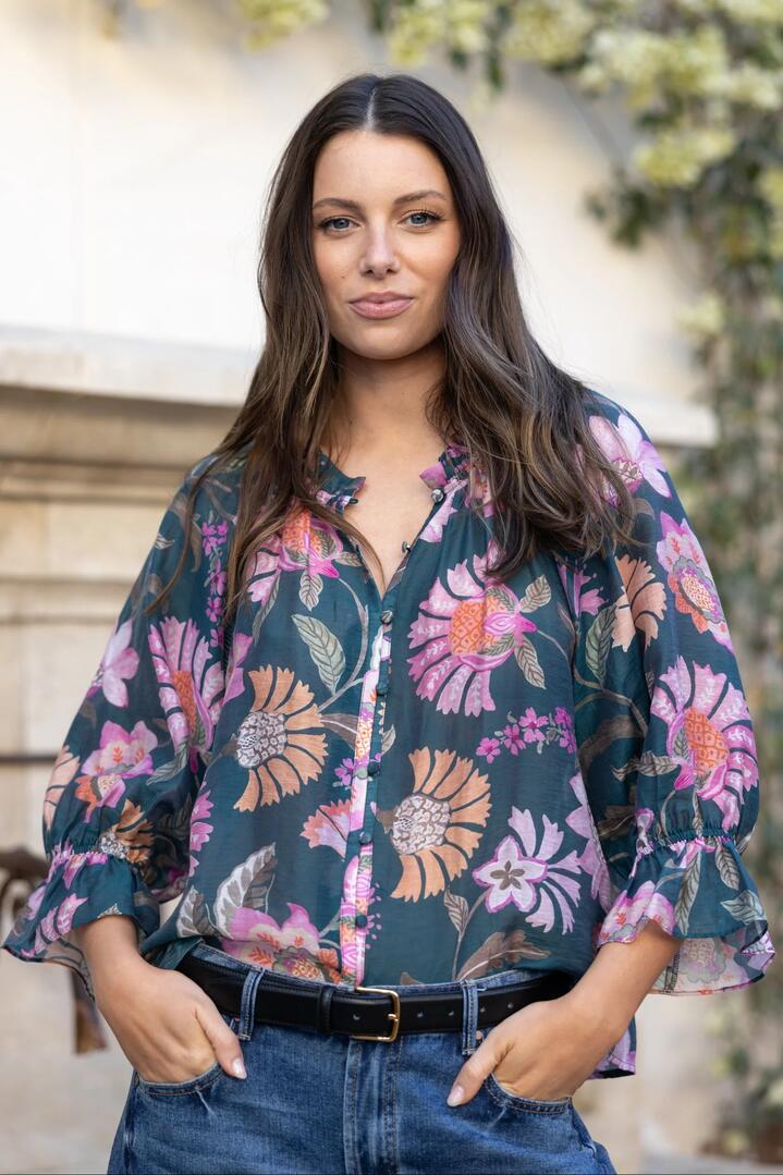 Image of a model wearing Tops. Product name - Encounter Petrol Scarf Print SS Gathered Button Front Top in Petrol Scarf Print colour by brand - By Rosa.