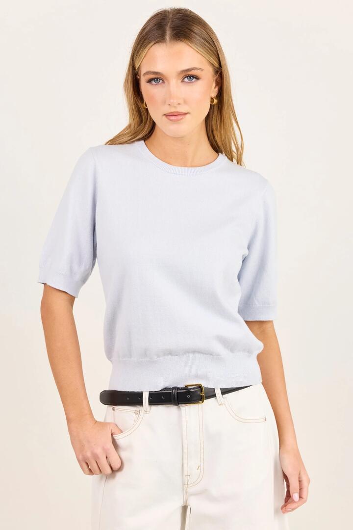 Image of a model wearing Outerwear. Product name - Edition Ice Blue Crewneck Cashmere Blend Knit Tee in Ice Blue colour by brand - Stories be Told