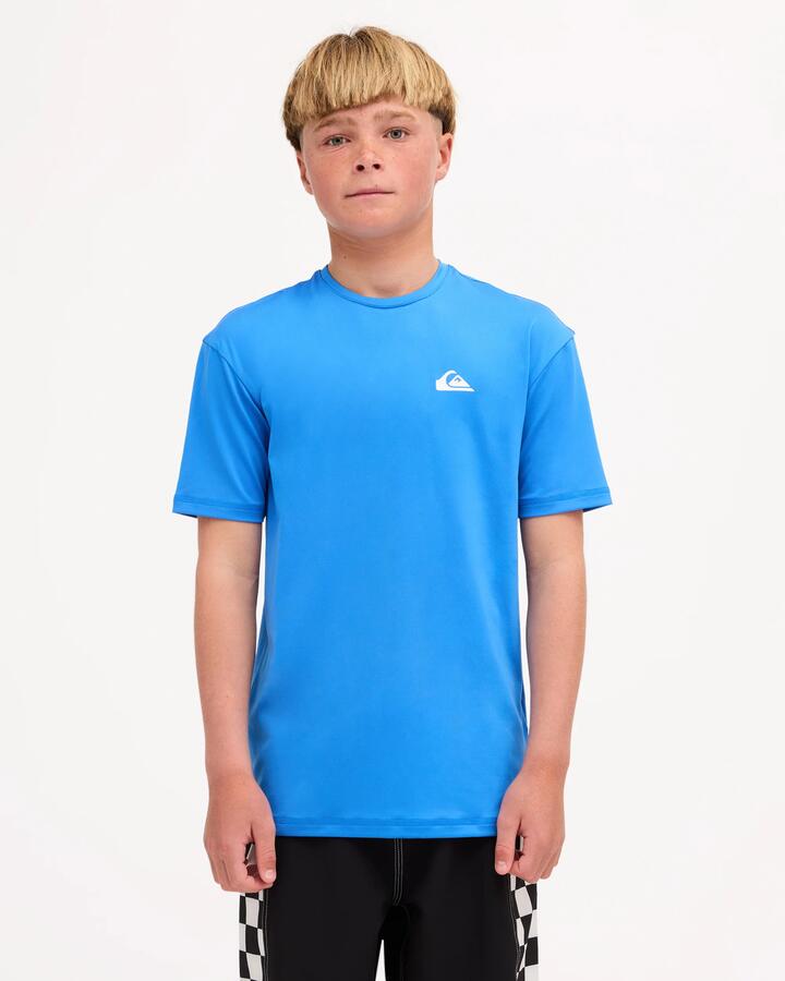 Image of a model wearing Tops. Product name - Quiksilver Boys 8-16 Logo Surf Short Sleeve Rashguard Palace Blue in Palace Blue colour by brand - Quiksilver