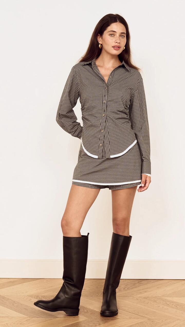 Image of a model wearing Tops. Product name - Fitted Waist Check Shirt with Contrast Hem in Check colour by brand - MINKPINK