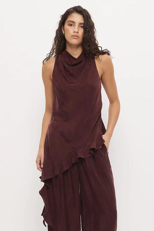 Image of a model wearing Tops. Product name - Eadie Chestnut Cowl Neck Asym Hem Ruffle Sleeveless Top in Brown colour by brand - Mon Renn