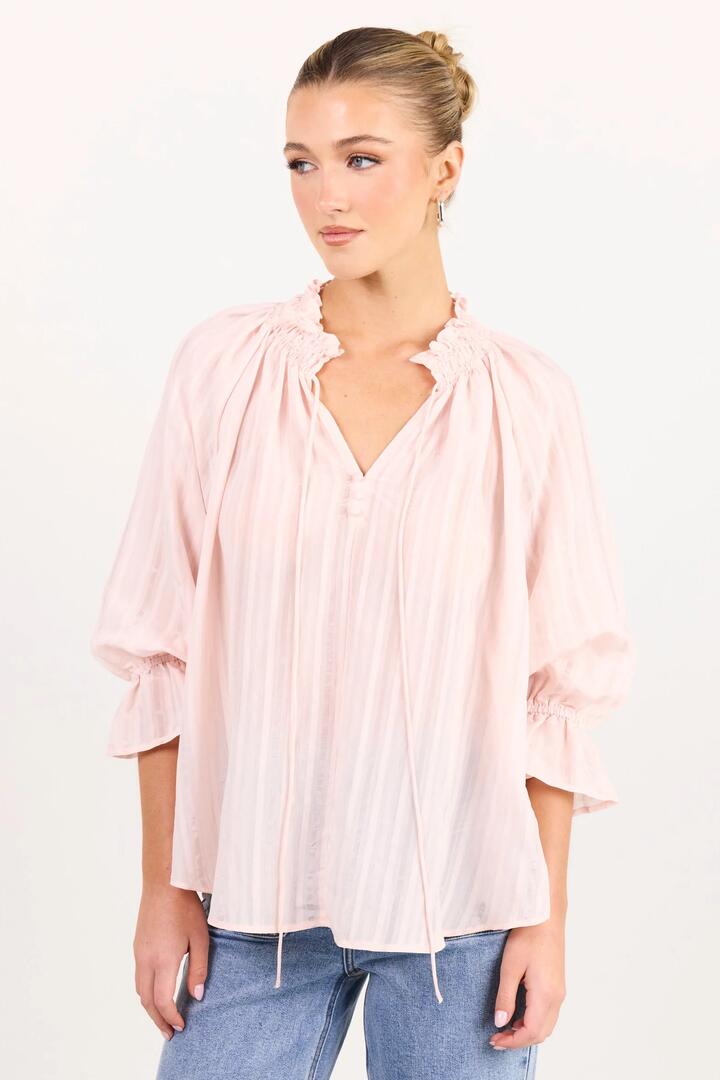 Image of a model wearing Tops. Product name - Expedition Blush Self Stripe Shirred Neck Short Sleeve Top in Blush Self Stripe colour by brand - Among the Brave