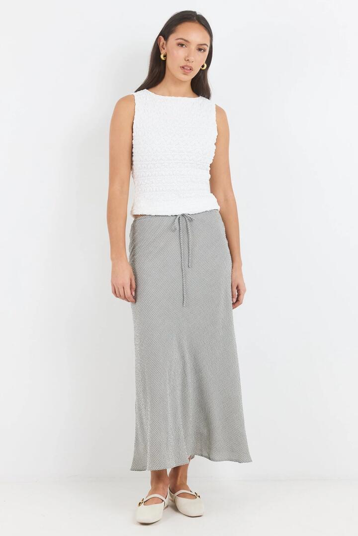 Image of a model wearing Skirts. Product name - Summit Khaki Mini Gingham Tie Waist Bias Maxi Skirt in Khaki Mini Gingham colour by brand - Among the Brave