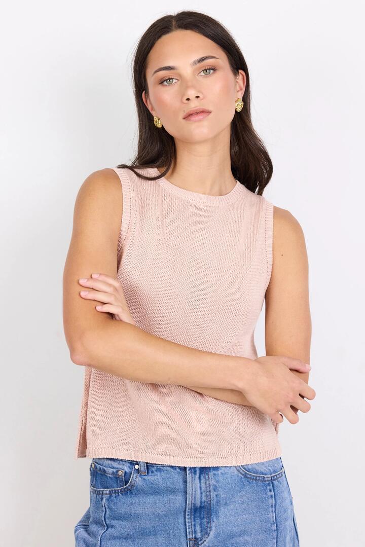 Image of a model wearing Outerwear. Product name - Salute Blush Relaxed Sleeveless Knit Top in Blush colour by brand - Among the Brave
