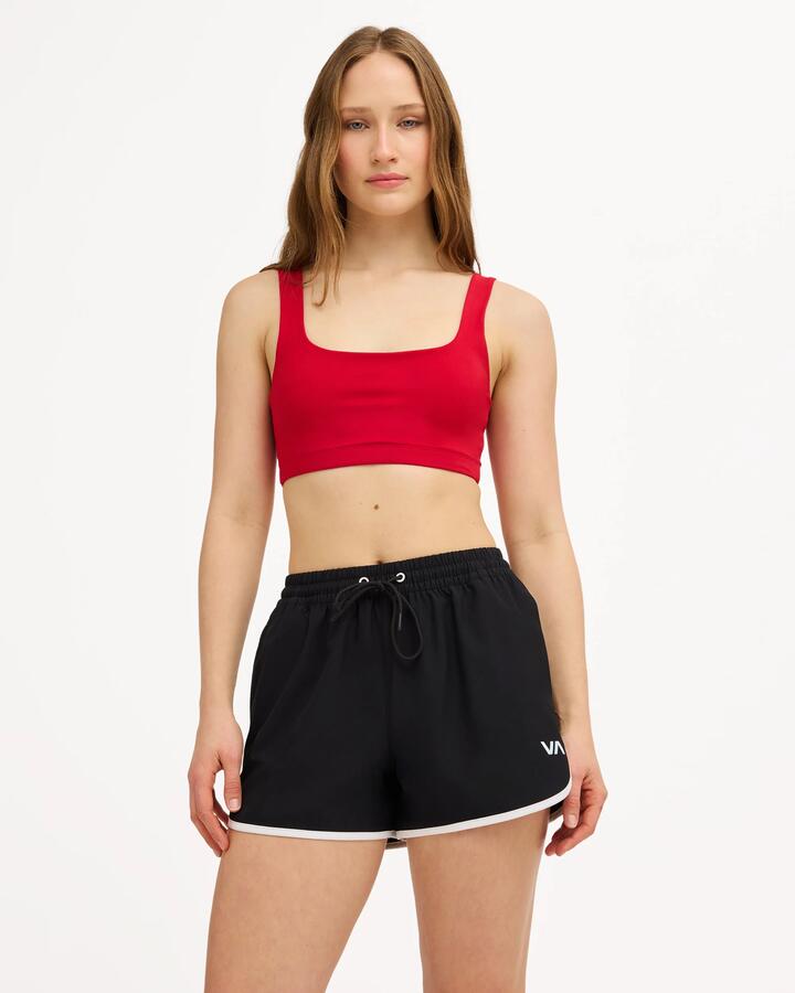 Image of a model wearing Tops. Product name - Surf Dive 'n Ski Womens Rvca Sports Crop Top Scarlet in Scarlet colour by brand - Surf Dive 'n Ski