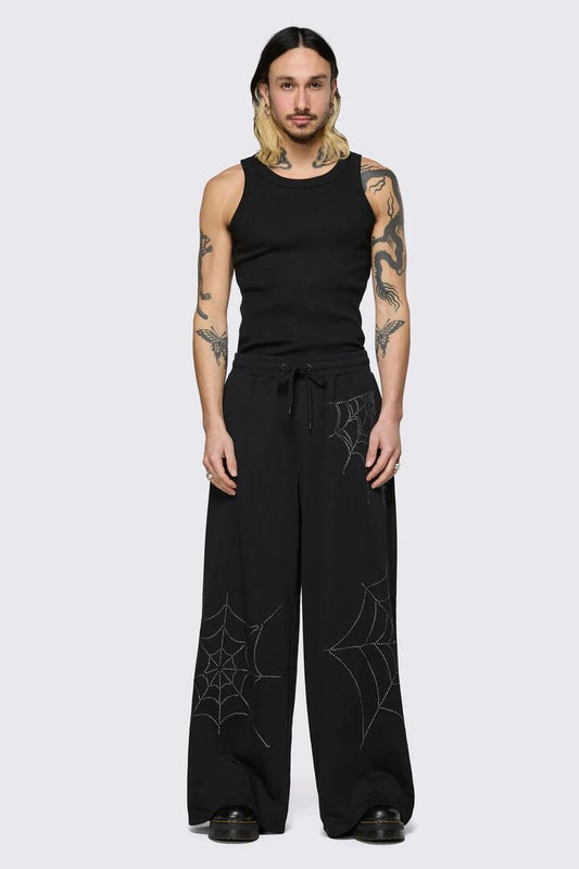 Image of a model wearing Pants. Product name - Webbed Diamante Track Pants in Black colour by brand - Black Friday