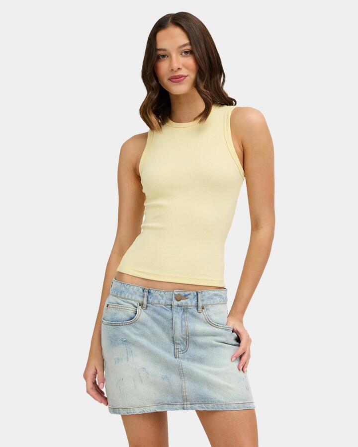 Image of a model wearing Tops. Product name - Nunui Womens Zander Tank Top Butter in Butter colour by brand - Nunui
