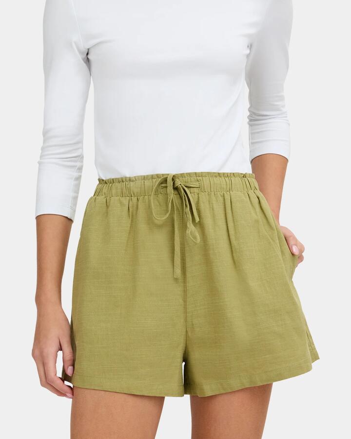 Image of a model wearing Shorts. Product name - Nunui Womens Roam Elastic Waist Shorts Sage in Sage colour by brand - Nunui