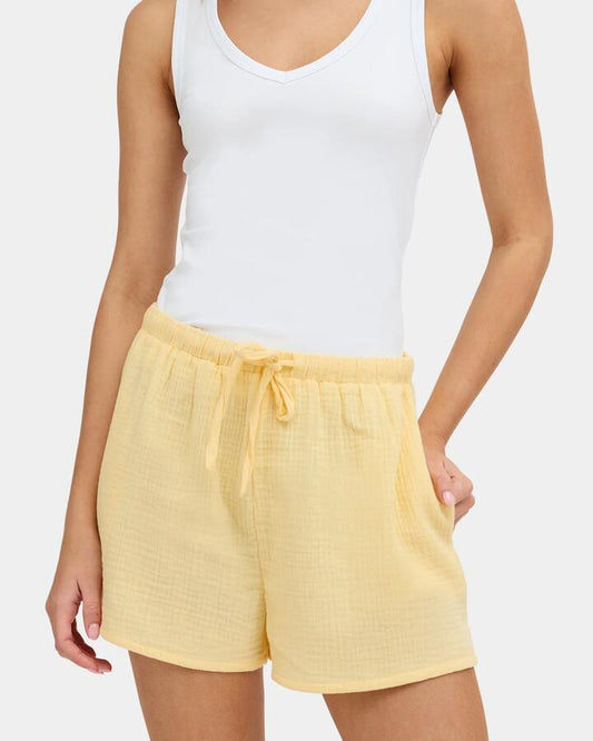 Image of a model wearing Shorts. Product name - Nunui Womens Paloma Elastic Waist Shorts Butter in Butter colour by brand - Nunui