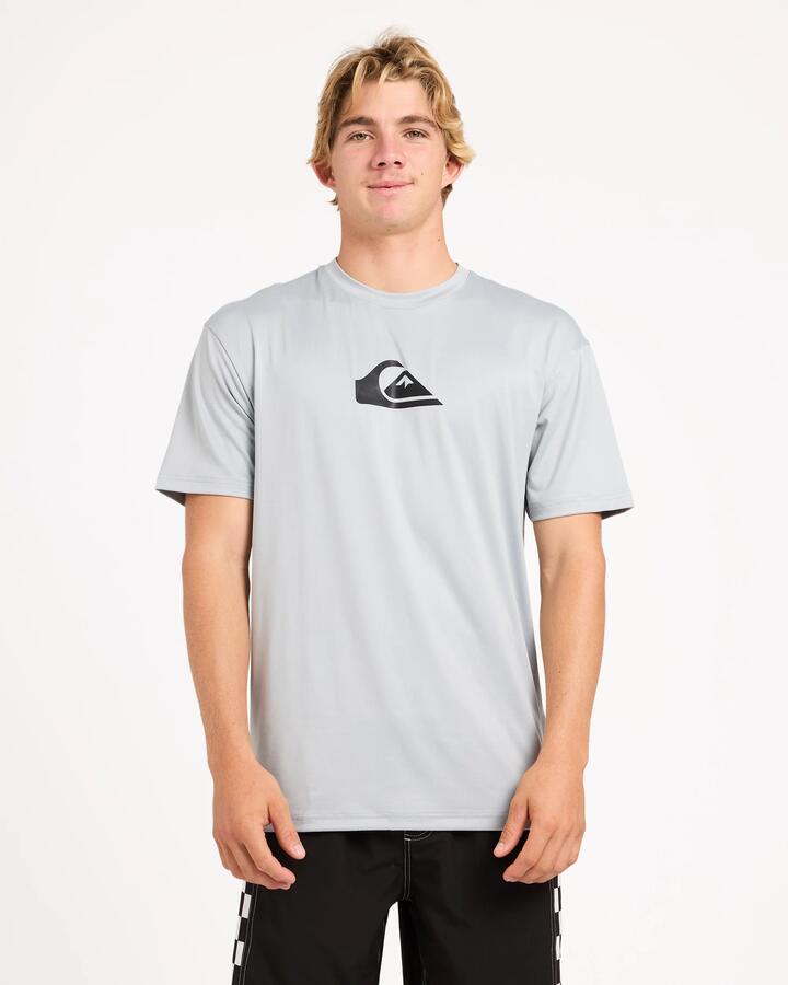 Image of a model wearing Tops. Product name - Surf Dive 'n Ski Mens Solid Streak Upf 50 Short Sleeve Surf Shirt Quarry in Quarry colour by brand - Surf Dive 'n Ski