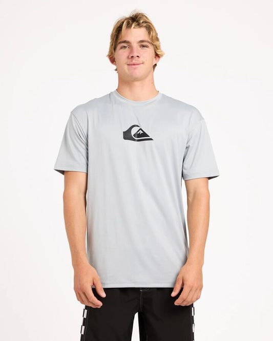 Image of a model wearing Tops. Product name - Surf Dive 'n Ski Mens Solid Streak Upf 50 Short Sleeve Surf Shirt Quarry in Quarry colour by brand - Surf Dive 'n Ski