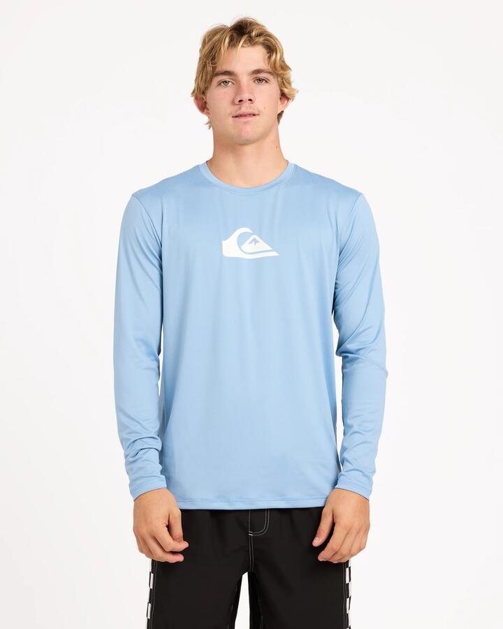 Image of a model wearing Tops. Product name - Surf Dive 'n Ski Mens Solid Streak Upf 50 Long Sleeve Surf Shirt Faded Denim in Faded Denim colour by brand - Surf Dive 'n Ski