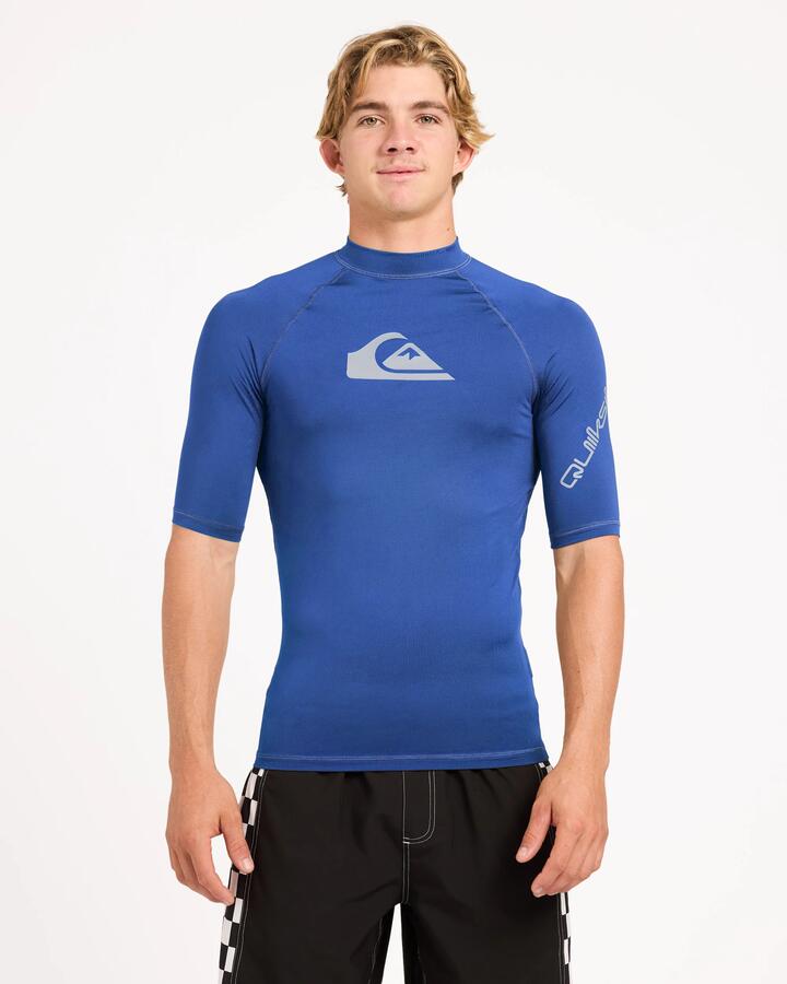 Image of a model wearing Tops. Product name - Surf Dive 'n Ski Mens All Time Upf 50 Short Sleeve Rashguard Monaco Blue in Monaco Blue colour by brand - Surf Dive 'n Ski