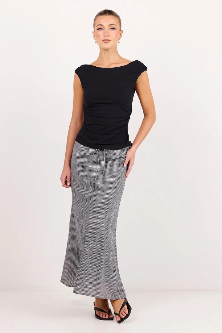 Image of a model wearing Skirts. Product name - Summit Black White Mini Gingham Tie Waist Bias Maxi Skirt in Black White Mini Gingham colour by brand - Among the Brave