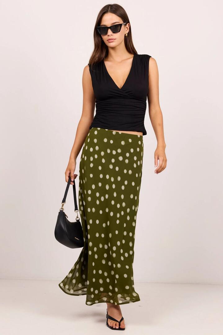 Image of a model wearing Skirts. Product name - Jubilant Olive Polka Dot Georgette Pull On Bias Maxi Skirt in Olive Polka Dot colour by brand - Georgia Zoe