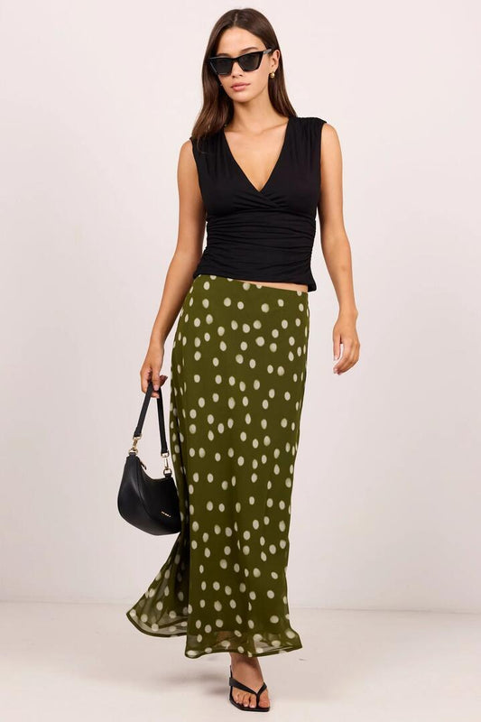 Image of a model wearing Skirts. Product name - Jubilant Olive Polka Dot Georgette Pull On Bias Maxi Skirt in Olive Polka Dot colour by brand - Georgia Zoe