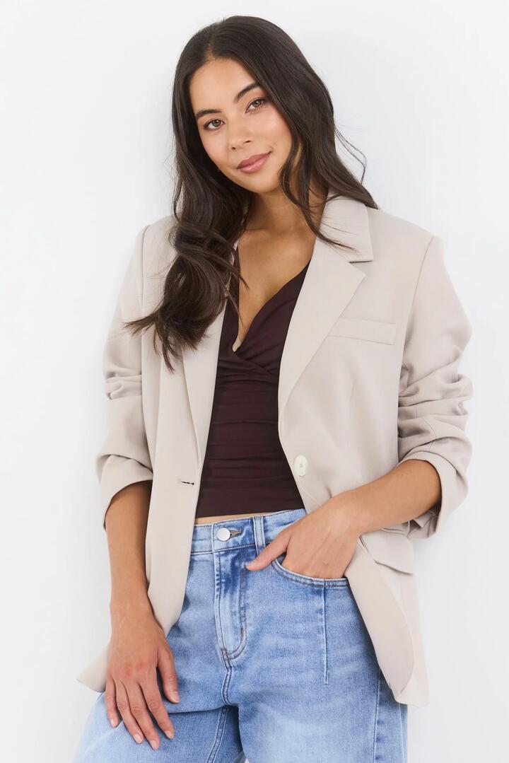 Image of a model wearing Outerwear. Product name - Confine Taupe Buttoned Sleeve Blazer in Taupe colour by brand - By Rosa.