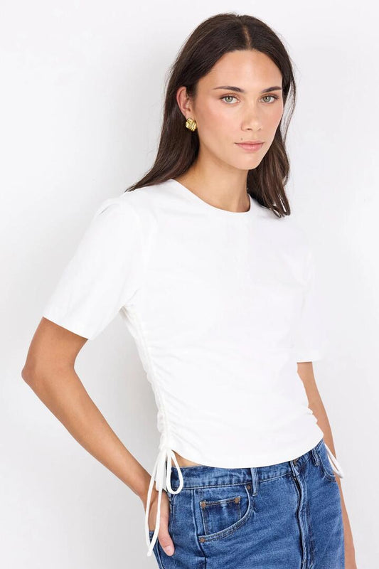 Image of a model wearing Tops. Product name - Lyrics White Tie Side Detail Tee in White colour by brand - Ivy + Jack