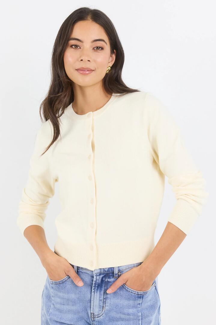 Image of a model wearing Outerwear. Product name - Autograph Butter Soft Fine Gauge Crewneck Cardigan in Butter colour by brand - Stories be Told
