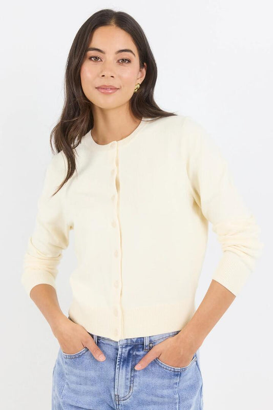 Image of a model wearing Outerwear. Product name - Autograph Butter Soft Fine Gauge Crewneck Cardigan in Butter colour by brand - Stories be Told