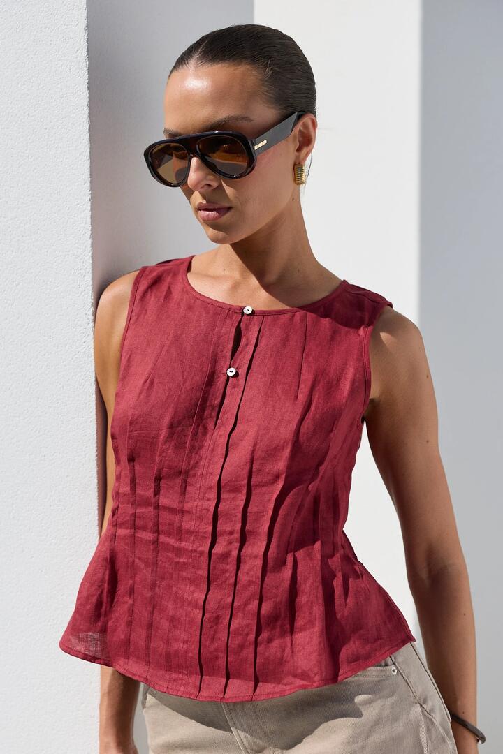 Image of a model wearing Tops. Product name - Encourage Wine Linen Pintuck Front Boatneck Top in Wine Linen colour by brand - Stories be Told