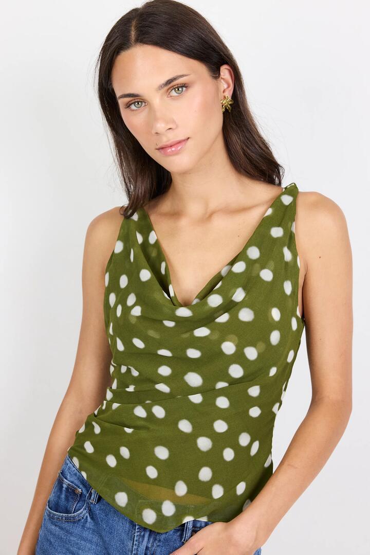 Image of a model wearing Tops. Product name - Fruitful Olive Polka Dot Georgette Tie Back Bias Slip Top in Olive Polka Dot colour by brand - Georgia Zoe
