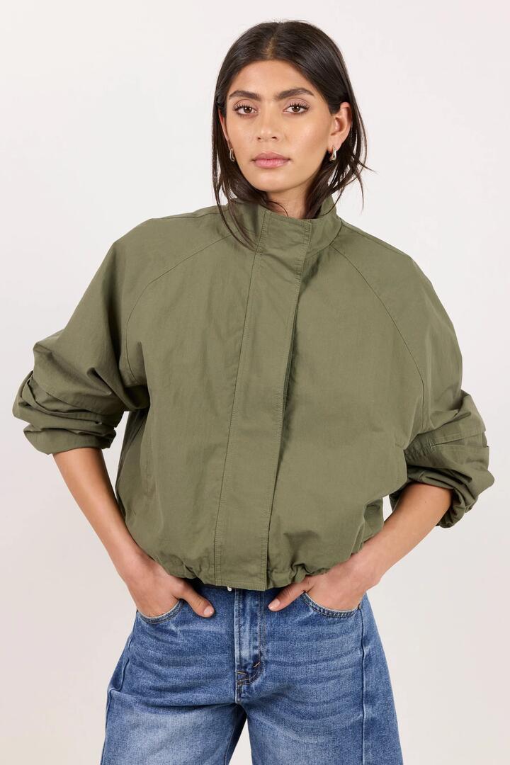 Image of Coats & Jackets. Product name - Trackside Khaki Funnel Neck Drawstring Hem Bomber Jacket in Khaki colour by brand - Stories be Told