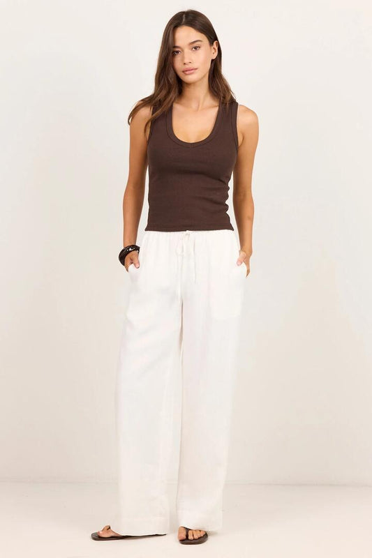 Image of a model wearing Pants. Product name - Wellness White Linen Pull On Wide Leg Pants in White Linen colour by brand - RE:UNION Label