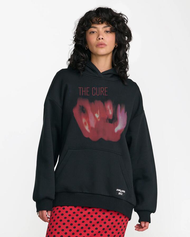 Image of a model wearing Outerwear. Product name - RVCA Womens The Cure Oversized Pullover Hoodie Black in Black colour by brand - RVCA