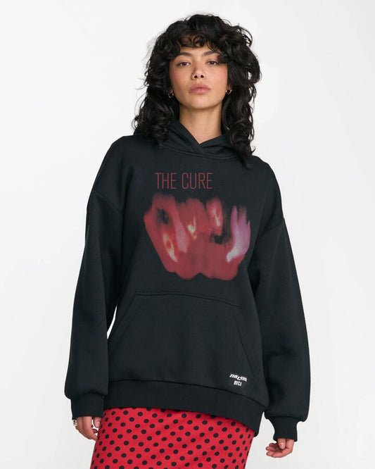Image of a model wearing Outerwear. Product name - RVCA Womens The Cure Oversized Pullover Hoodie Black in Black colour by brand - RVCA