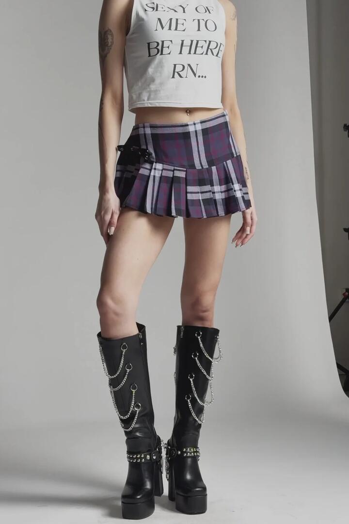 Image of a model wearing Skirts. Product name - Monstre Tartan Skort in Purple colour by brand - Black Friday
