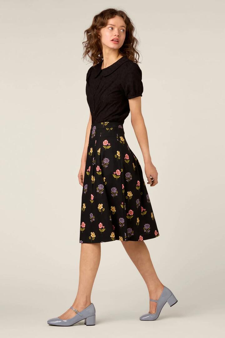 Image of a model wearing Skirts. Product name - Meika 90s Flower Skirt in Black colour by brand - Princess Highway
