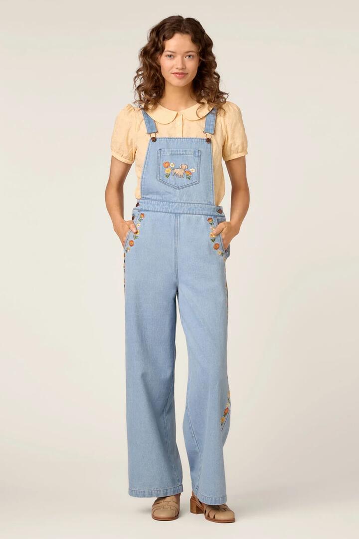 Image of a model wearing Pants. Product name - Sweet Dog Embroidered Overall in Blue Denim colour by brand - Princess Highway